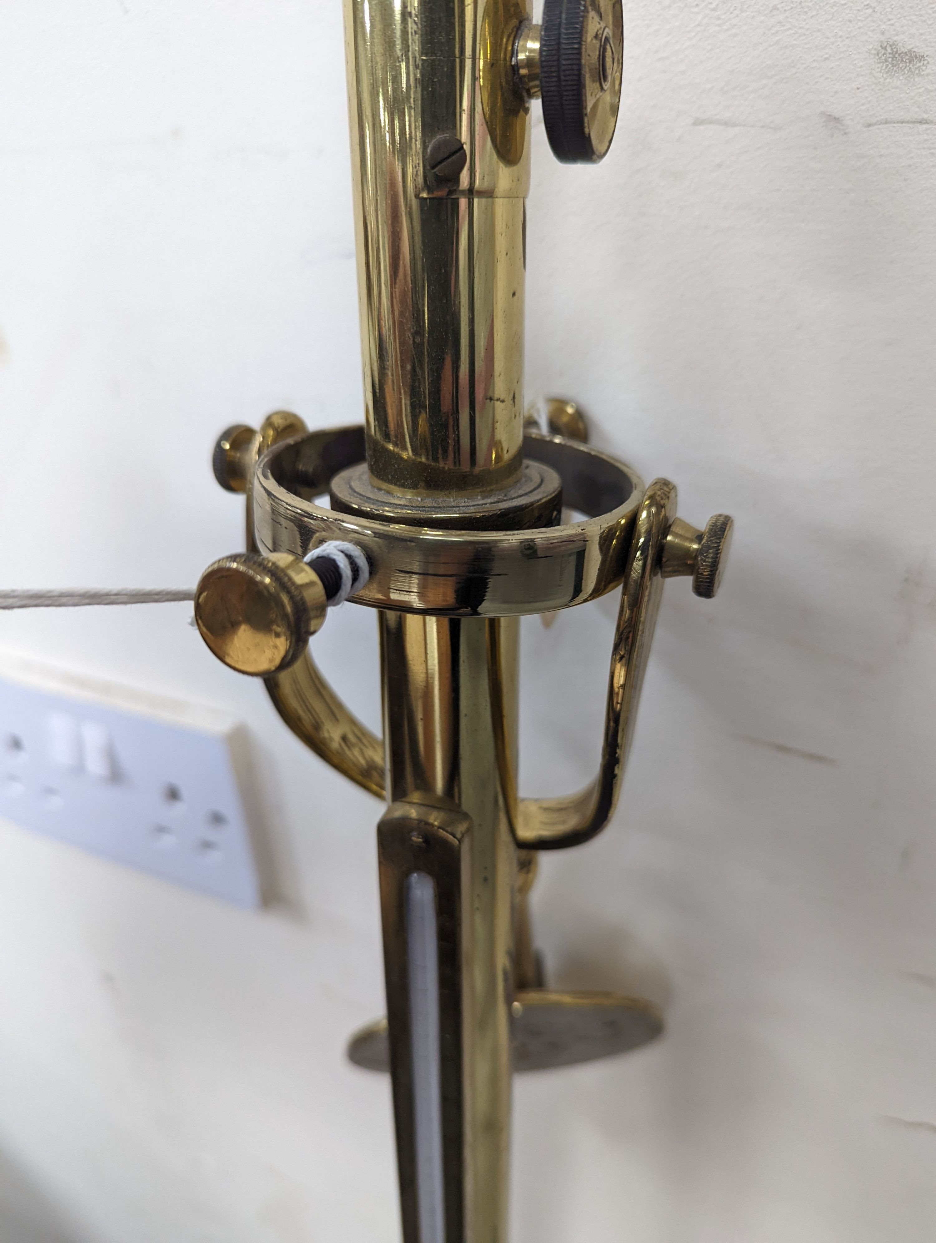 A brass ship's barometer and thermometer with gimbled wall mount, height 100cm